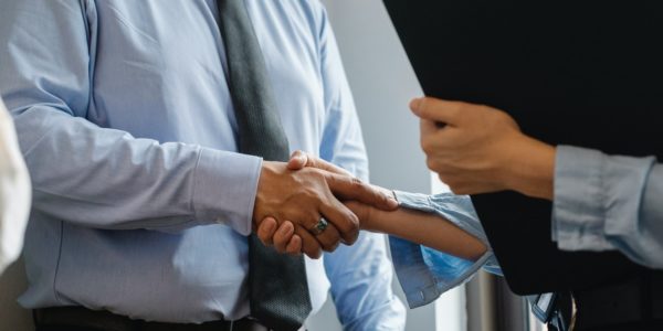 man shaking hands with a woman