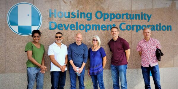 group of people standing behind HODC logo