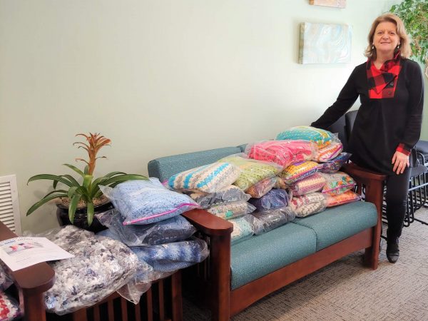 woman standing with some fabric on the couch