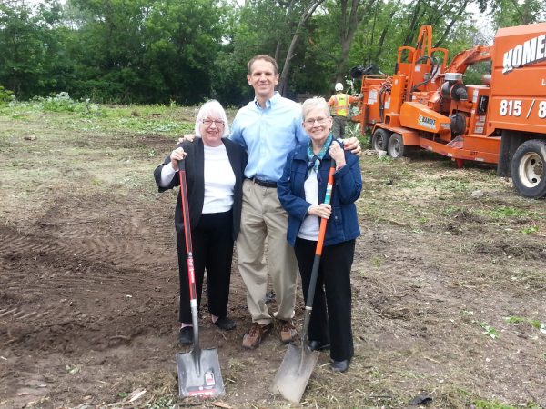 group photo holding a shovel