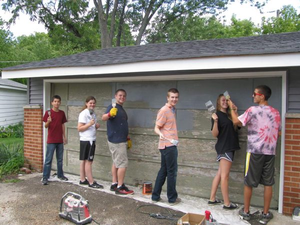 group of youth painting the house