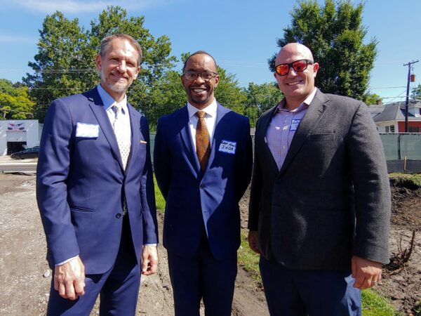 Three men smiling