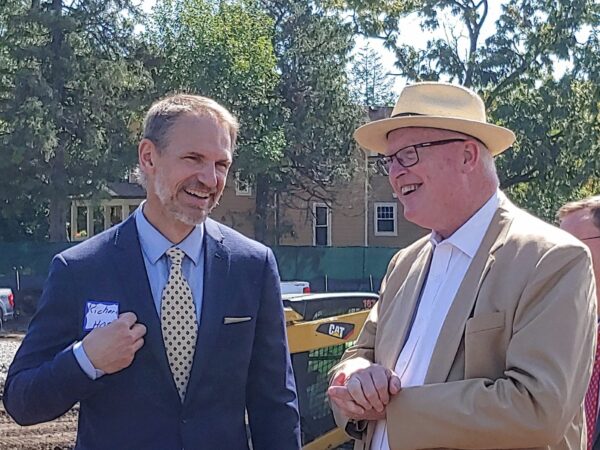 Two men smiling