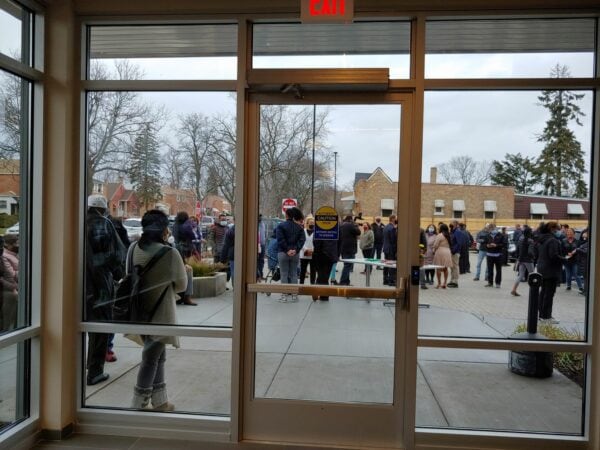 View of people outside through door