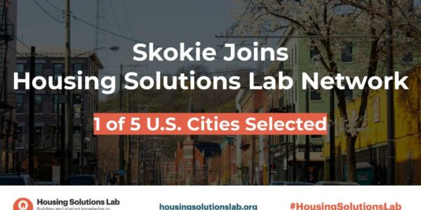 "Skokie joins Housing Solutions Lab Network. 1 of 5 U.S. Cities Selected" Text in front of photo of a city street with various buildings. Housing Solutions Lab logo at the bottom with housingsolutionslab.org.