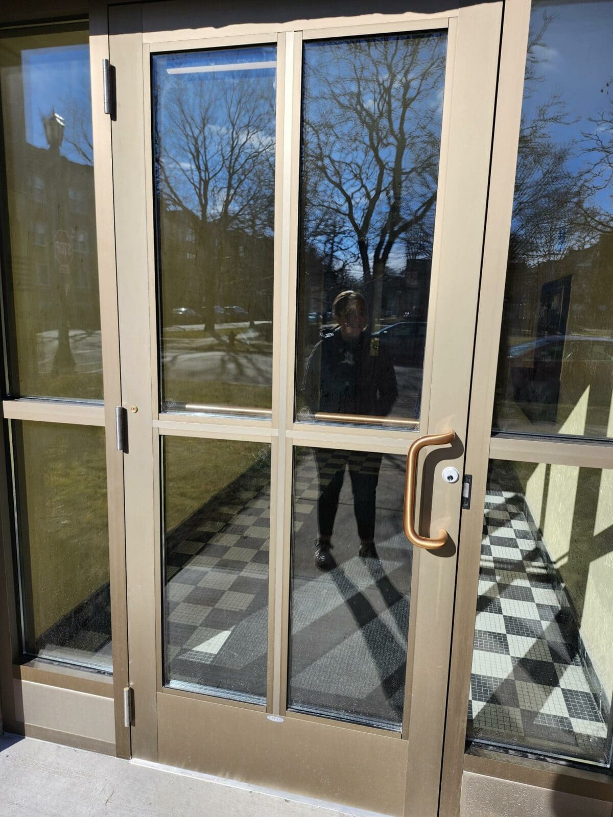 External door with large glass panes and brown metal frame.