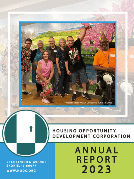 Front page of HODC's 2023 Annual Report. Picture of smiling people in front of a large mural.
