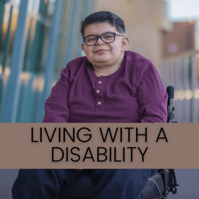 Living With A Disability: a person with short hair and glasses in a wheelchair