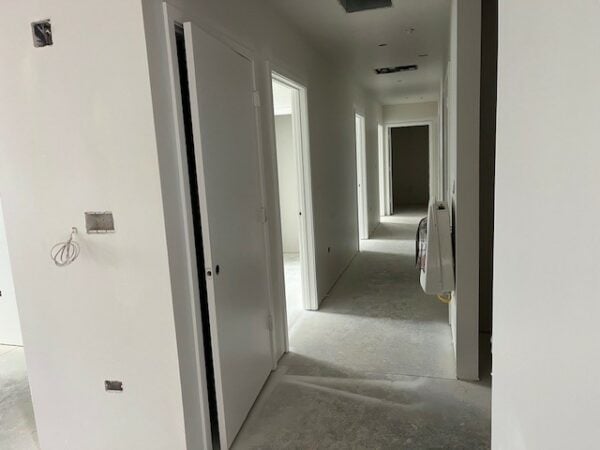Painted hallway with multiple open doors.
