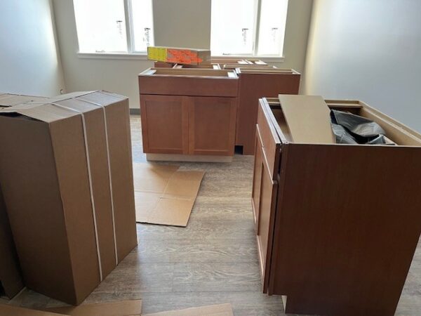 Cabinets wait to be installed in a construction site.