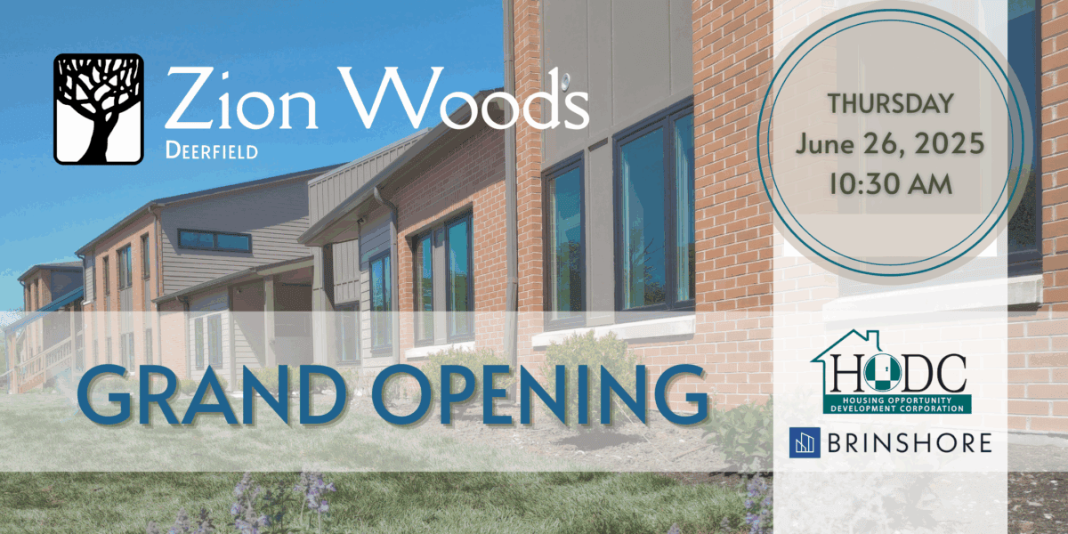 Two story apartment building with light brown bricks and taupe siding. Grand Opening in blue text. Logos for Zion Woods, HODC, and Brinshore.