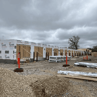 A row of garages have been framed and are waiting for roofs.