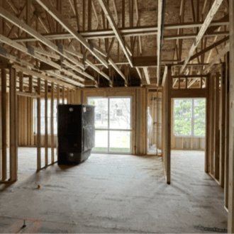 Interior of a construction site that is framed in preparation for walls.