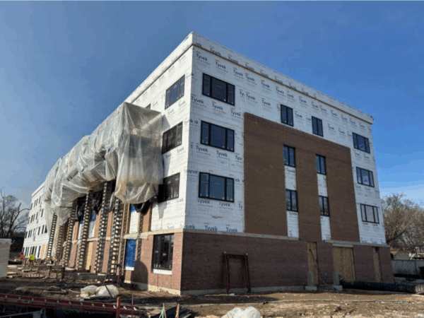 A partially completed four-story apartment building under construction.
