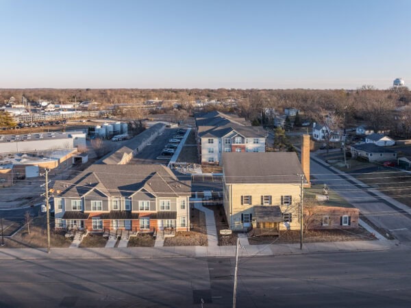 Aerial view of a Taylor Place Apartments residential neighborhood with houses and streets.