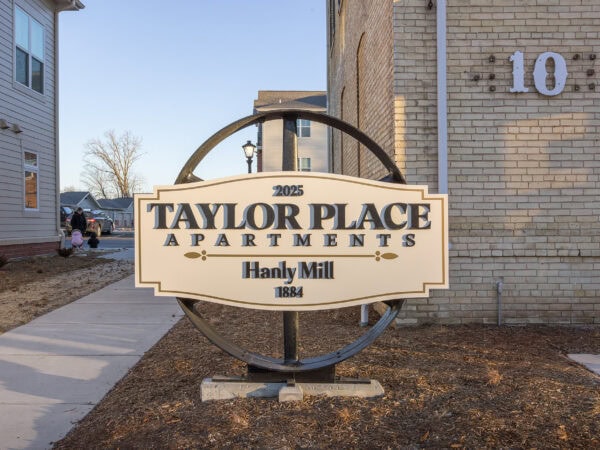 Sign for Taylor Place Apartments at 2025, with Hanly Mill 1884 branding.