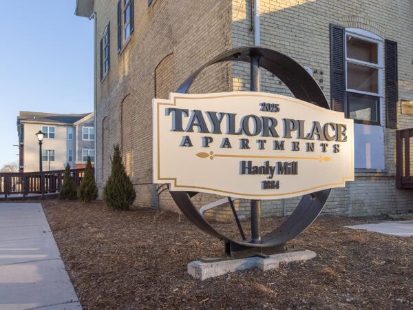 Sign for Taylor Place Apartments at Hanly Mill, 2023.