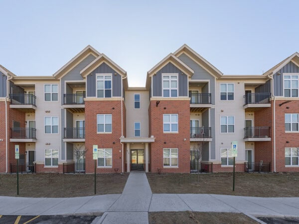 Apartment building with multiple units and balconies in a residential community.