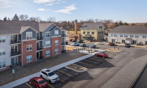 Apartment complex with parking lot and residential buildings in a suburban area.
