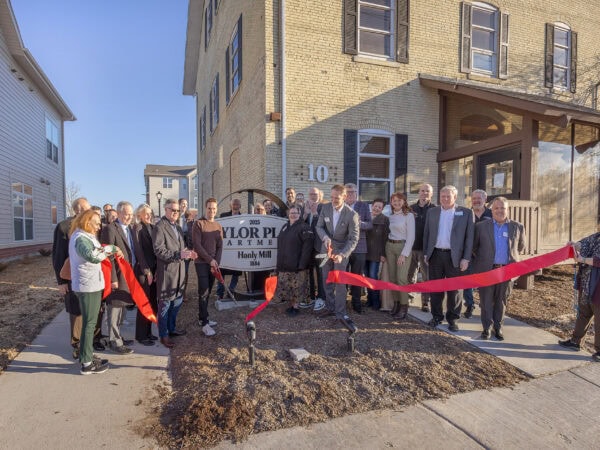 Ribbon cutting ceremony for new community housing development.