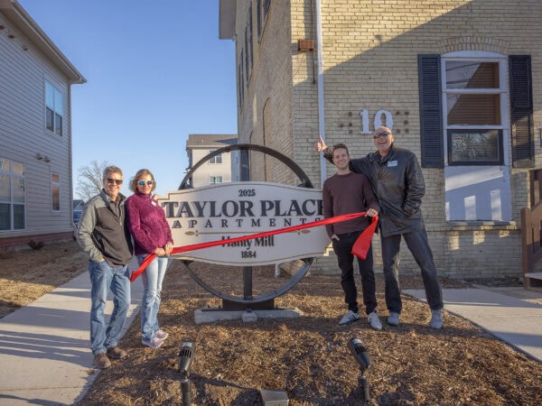 Group of people at Taylor Place Apartments grand opening event.
