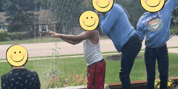 Children playing in a sprinkler.